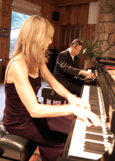 Mireille and Francisco Silva playing together at the grand piano