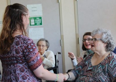 elderly residents congratulate students