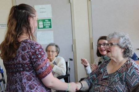 elderly residents congratulate students