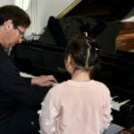 Dr. Silva instructing at the piano