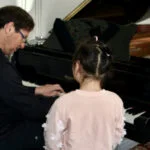 Dr. Silva instructing at the piano