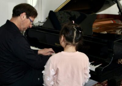 Dr. Silva instructing at the piano