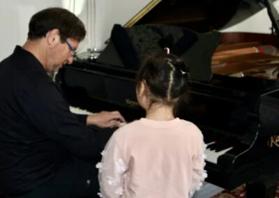 Dr. Silva instructing at the piano