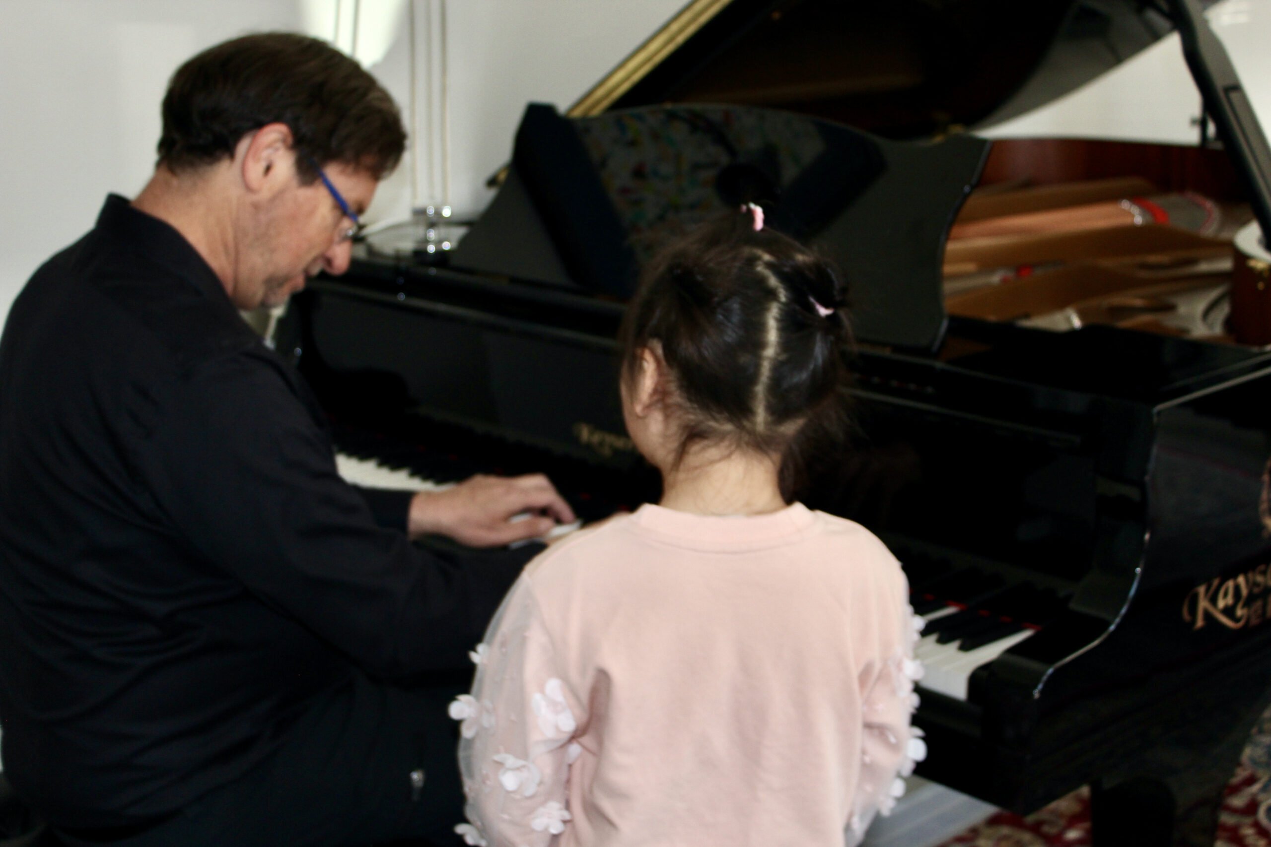 Dr. Silva instructing at the piano