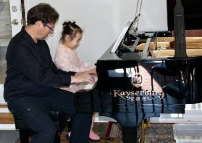 Hannah, age 5 at the piano with Dr. Silva