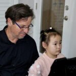 Hannah, age 5 at the piano with Dr Silva