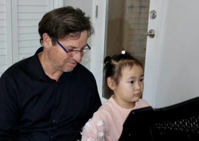 Hannah, age 5 at the piano with Dr Silva