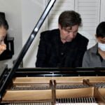 Students receiving instruction at the piano