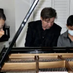Students receiving instruction at the piano