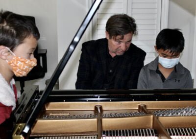 Students receiving instruction at the piano