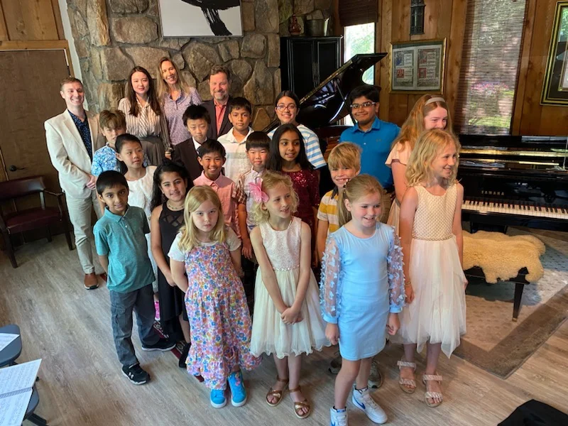 group shot of students and teachers at recital space